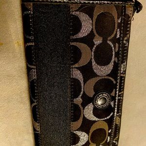 A Coach wristlet, in good condition